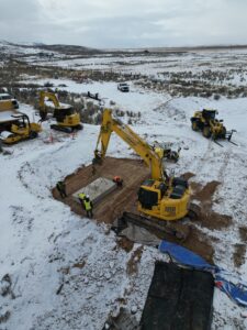 Large excavator operating in winter conditions in Wyoming, USA.